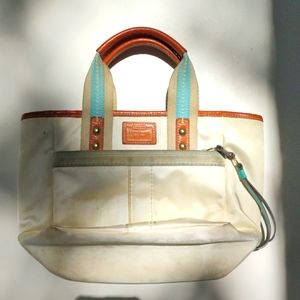 White satin small Coach bag needs cleaning
